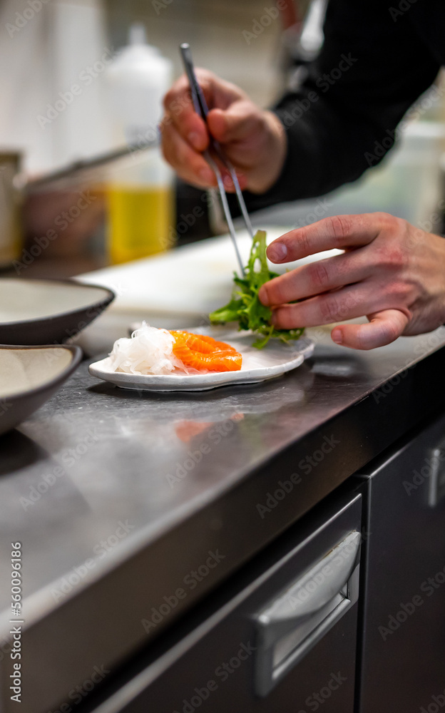 chef cooking slice salmon fish and shrimp with salad on kitchen chef cooking slice salmon fish and shrimp with salad on kitchen