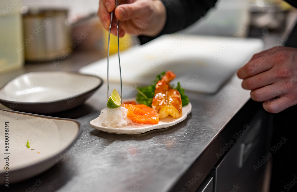 chef cooking slice salmon fish and shrimp with salad on kitchen chef cooking slice salmon fish and shrimp with salad on kitchen