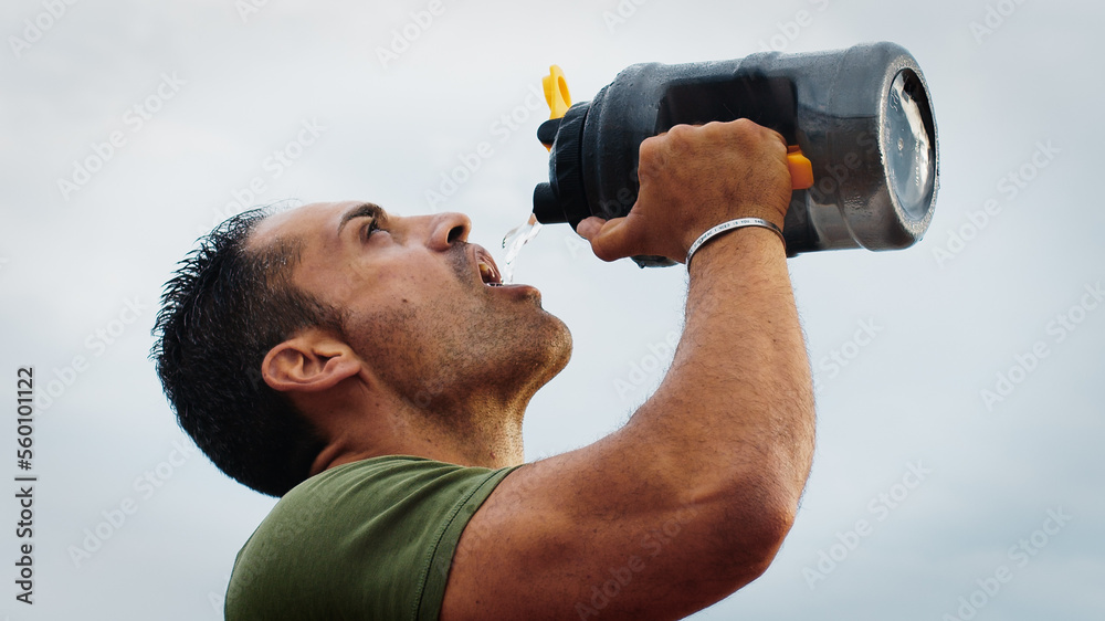 Athlete quenches his thirst with bottles of water