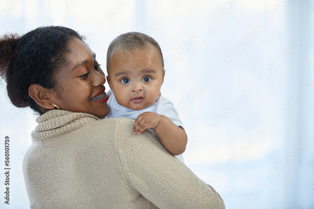 African young mother hugging and carrying a little baby African young mother hugging and carrying a little baby