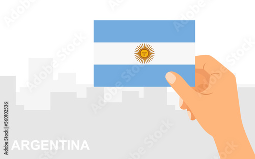 Hand holding the flag of Argentina on the background of the city in minimal flat style. Vector illustration