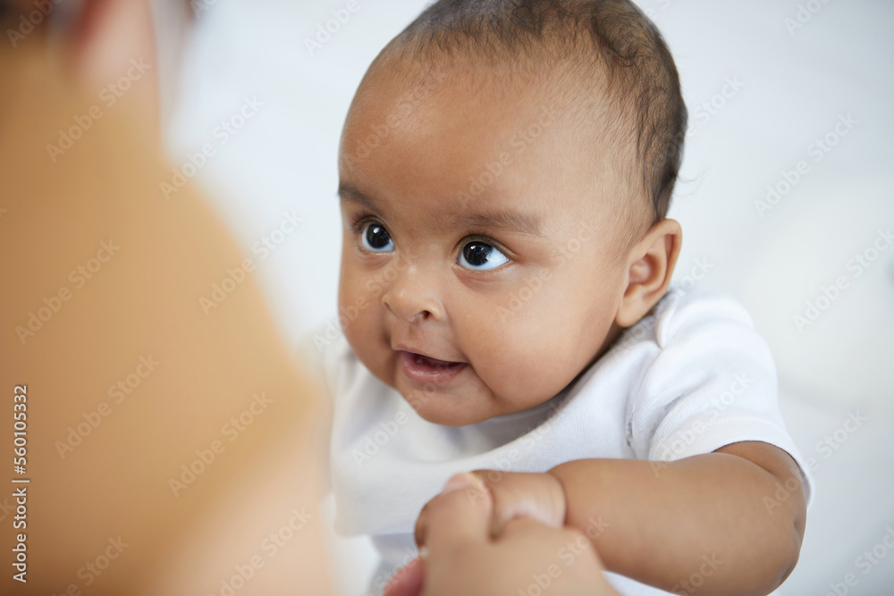 African baby girl learning to walk and mother or sitter holding hands on bedroom African baby girl learning to walk and mother or sitter holding hands on bedroom