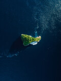 Scenic rock island in ocean nearby Nusa Penida. Aerial view