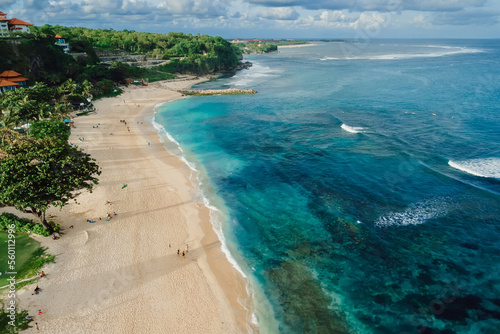 Beach with blue ocean and waves in Bali island. Aerial view