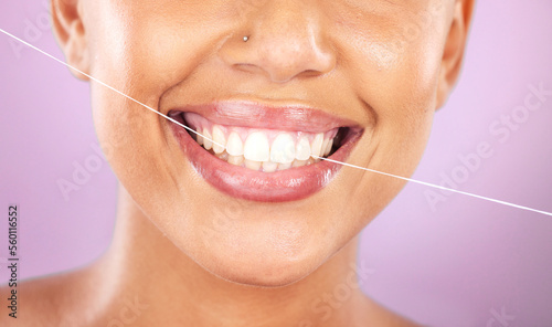 Teeth, dental floss and beauty with woman, face zoom and smile, cosmetic and oral healthcare against purple background. Flossing, fresh breath and health for mouth, teeth whitening with Invisalign.
