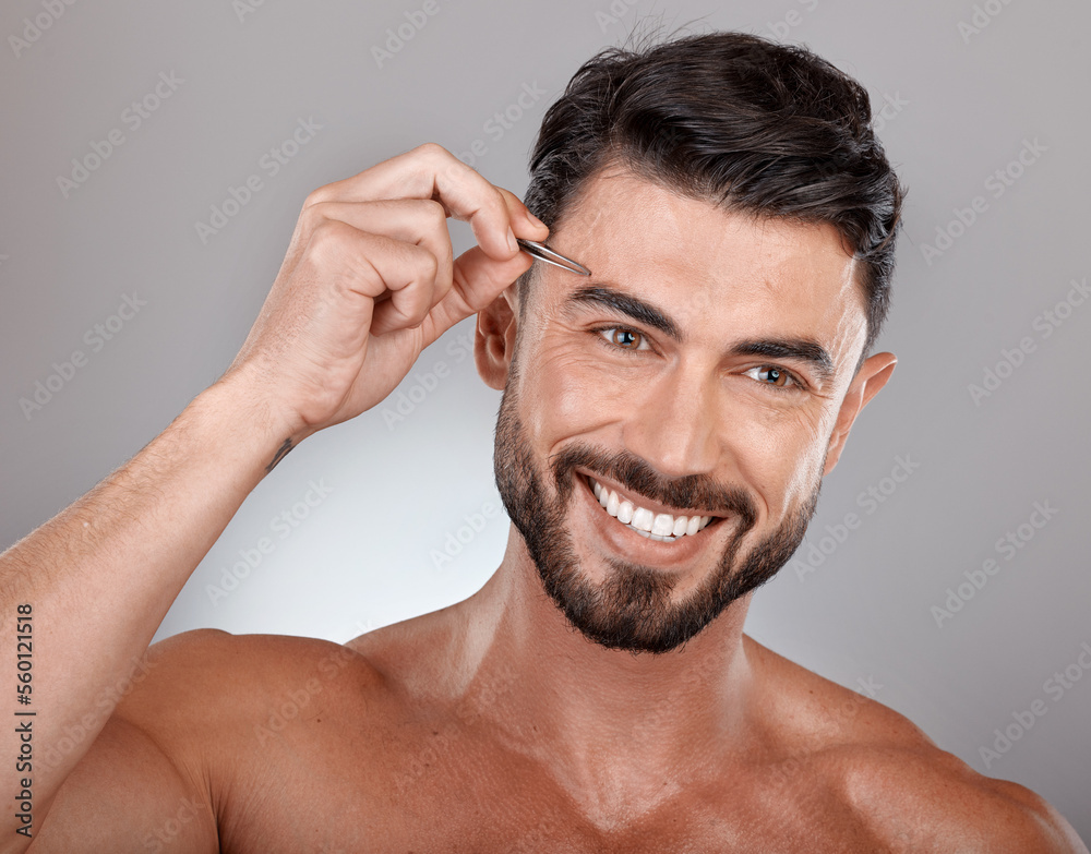 Obraz premium Man, eyebrow tweezers and face hair removal for skincare beauty, grooming wellness and hygiene happiness in grey studio background. Model smile, cosmetics facial care and dermatology or microblading