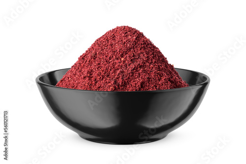 Dry ground sumac in black bowl isolated on white. Front view. photo
