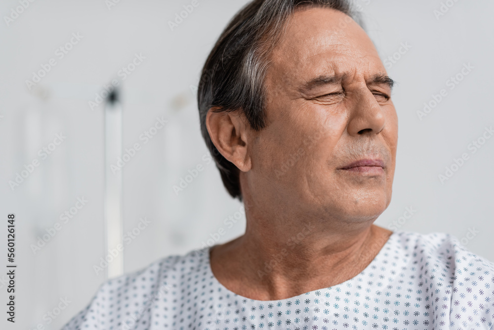 Sick senior patient suffering from pain in clinic. Sick senior patient suffering from pain in clinic.