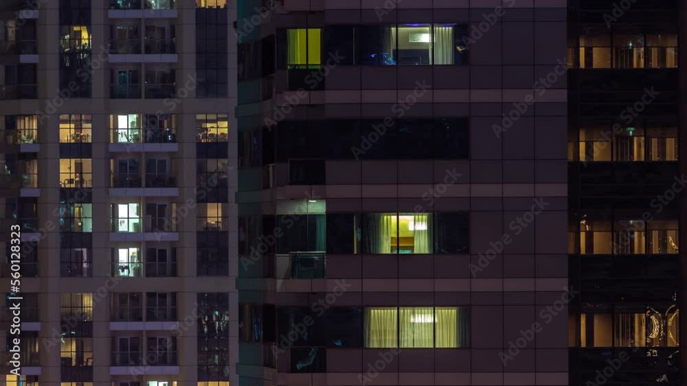 Night view of lights in panoramic windows of multistory buildings aerial timelapse. Illuminated skyscraper in a big city Night view of lights in panoramic windows of multistory buildings aerial timelapse. Illuminated skyscraper in a big city