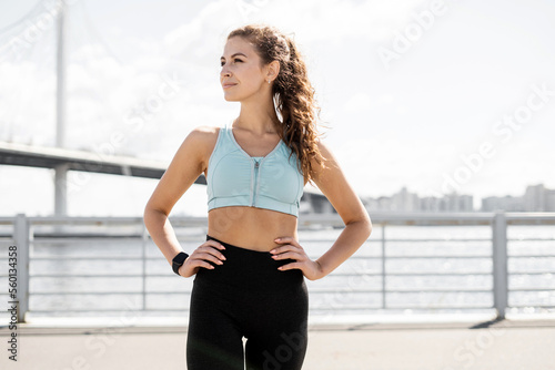 A sporty woman in sportswear training outdoors. A fitness athlete performing. © muse studio