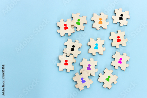 Business image of wooden puzzle with people icons over blue background  human resources and management concept