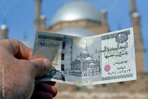 The great mosque of Muhammad Ali Pasha or Alabaster mosque in Citadel of Cairo from the obverse side of 20 LE twenty Egyptian pounds money banknote and the real mosque blurred in background photo