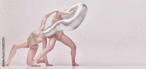 Human being. Creative photography with two young girls posing in nude underwear over beige studio background. Concept of cringe, queer, weird people photo