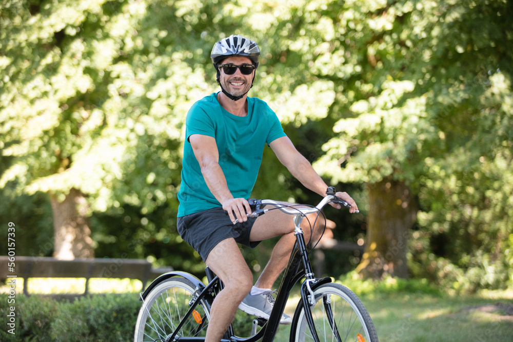 man with his bike enjoying driving in park