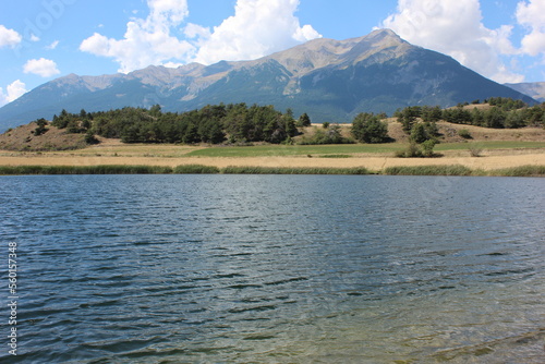 Alpine landscape in the Hautes-Alpes with on the mountains, lake and sky.