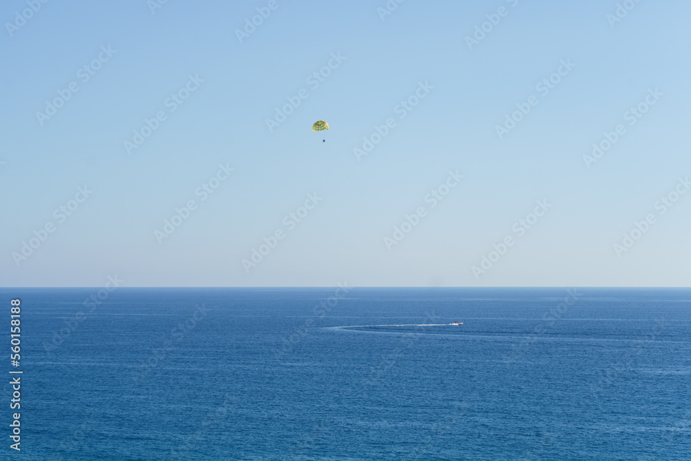 People Parasailing Over Sea Against Sky People Parasailing Over Sea Against Sky