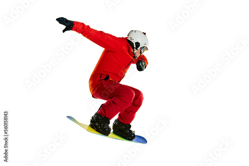 Doing tricks. Portrait of active man, snowboarder in uniform riding on snowboard isolated over white studio background. Concept of winter sport, action, motion