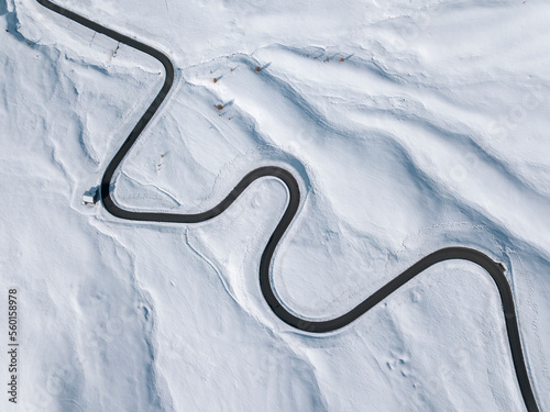 Aerial view of a winding road in the snow in Passo Giau, high alpine pass. Dolomites, Italy. Winter nature background. © szaboerwin