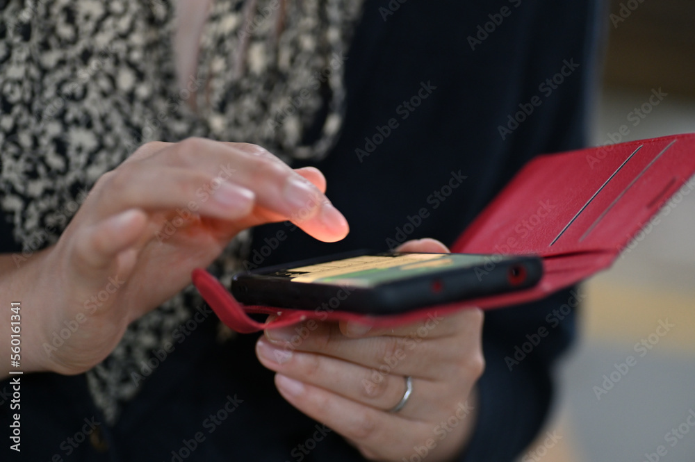 Obraz premium スマートフォンを操作してディスプレイの光で指が照らされている