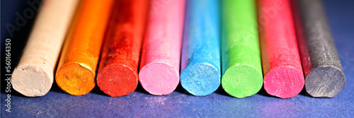 Multicolored chalk, metallic rainbow colors,  as a background. The concept of celebration and fun. Long banner.
