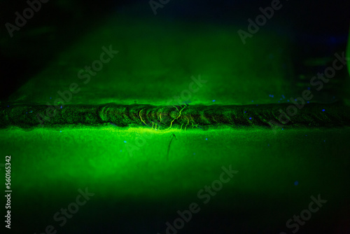 Crack steel butt weld carbon background green contrast magnetic filed photo