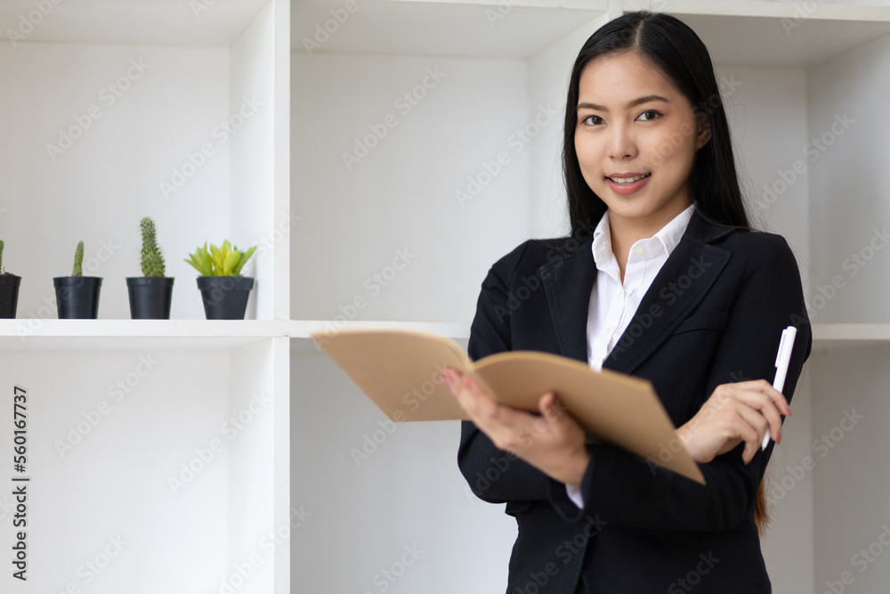Portrait of an attractive Asian secretary or businesswoman in the office. Portrait of an attractive Asian secretary or businesswoman in the office.
