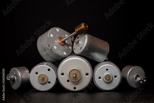 Various dc electric motors on black background
