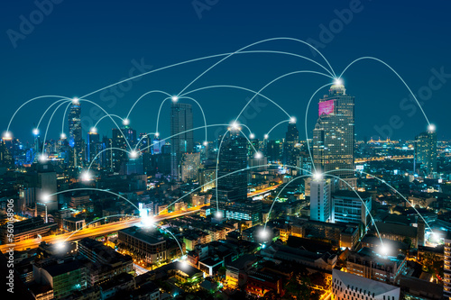 Smart city telecommunication network concept, connection lines over the night cityscape