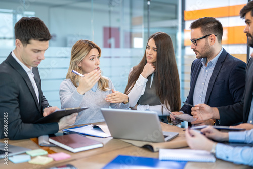 Businesswoman leading business presentation in conference room.