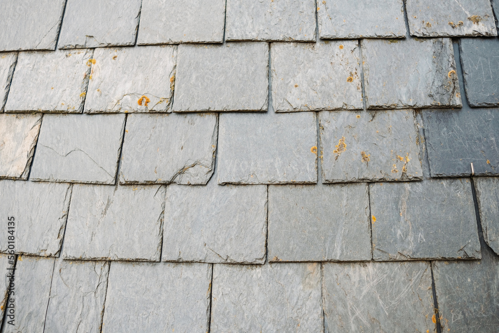 Fototapeta premium Detail of slate tiles on a medieval roof, a traditional way of insulating houses.