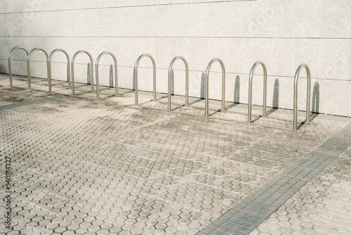 Bars to park bicycles, empty, installed at the entrance of a building.