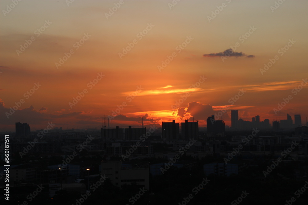 dark storm cloudy sky in rainy day on sunset time with city building background 