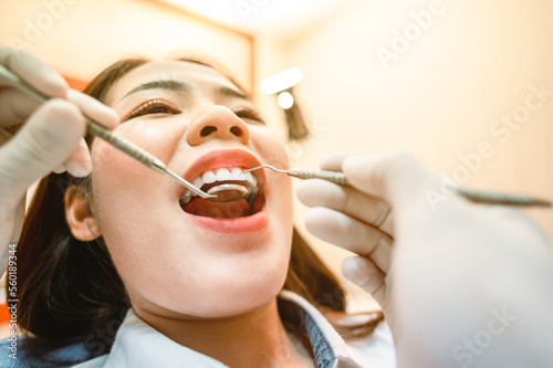 Dentist examining teeth patients in clinic for better dental health and a bright smile.Dentist checking teeth with tools.Dentist tools and equipment.