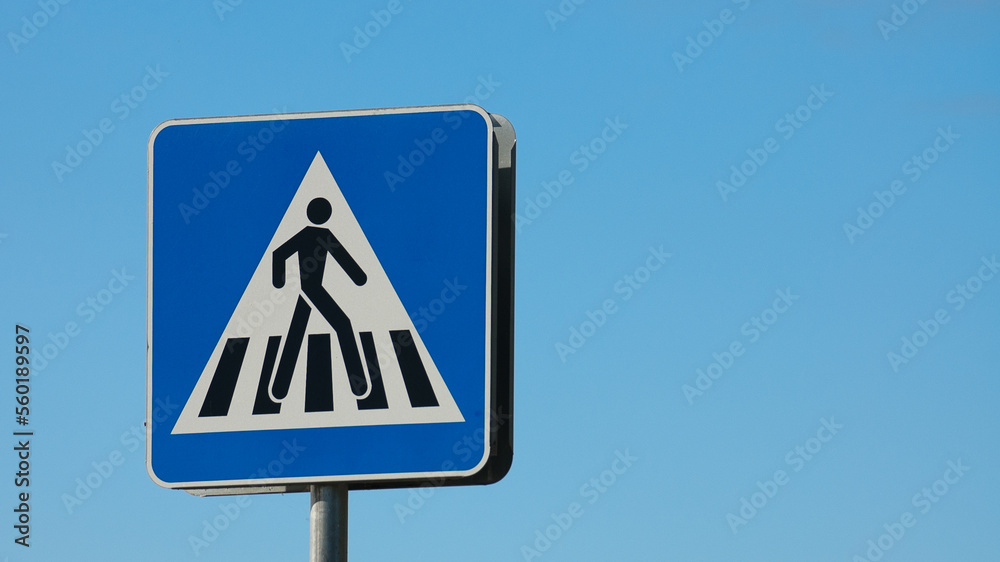 road sign pedestrian crossing close-up against the blue sky road sign pedestrian crossing close-up against the blue sky