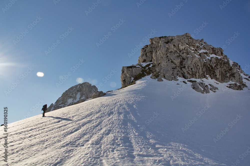 girl climbs a snowy slope on snowshoes to reach the top of Pico Aguja, Asturias.