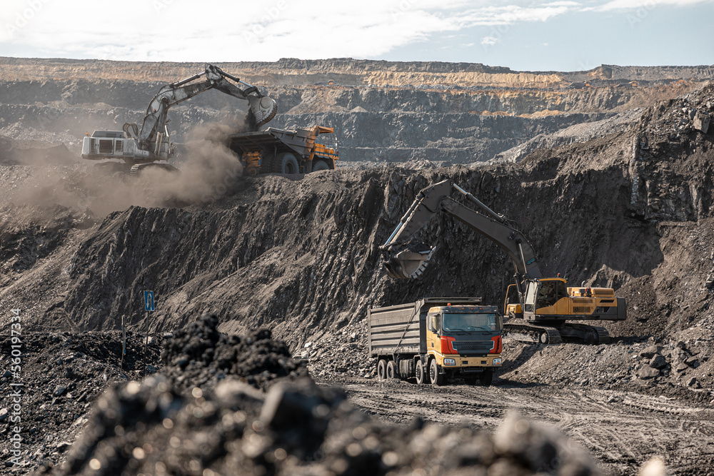 Large quarry dump truck. Big yellow mining truck at work site. Loading ...
