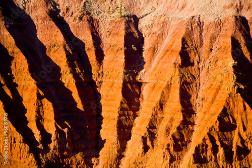 Sunrise colors and deep shadows in the Claron Formation of the Pink Cliffs of red sandstone in Southern Utah. photo