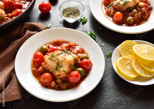 Fototapeta Naklejka Na Ścianę i Meble -  Cod stew with chickpeas, cherry tomatoes and olives