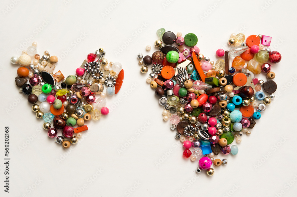 Frame in the shape of hearts. Background of multicolored decorative craft beads. Valentine's Day. Symbol of love. Frame in the shape of hearts. Background of multicolored decorative craft beads. Valentine's Day. Symbol of love.