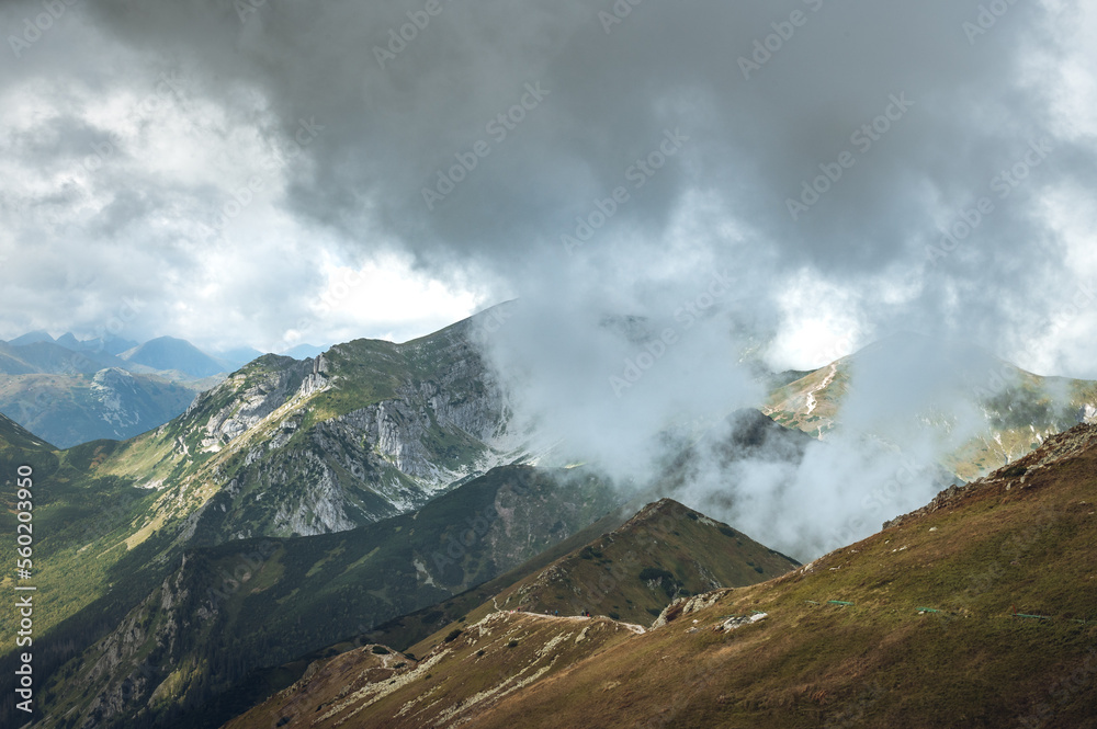 Breathtaking views over the valley of impressive Tatra mountains in misty weather. National park in Zakopane, Poland. Breathtaking views over the valley of impressive Tatra mountains in misty weather. National park in Zakopane, Poland.