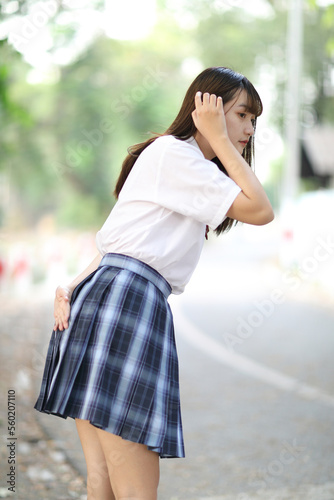 beautiful asian japanese school girl uniform looking at park outdoor © Oran Tantapakul