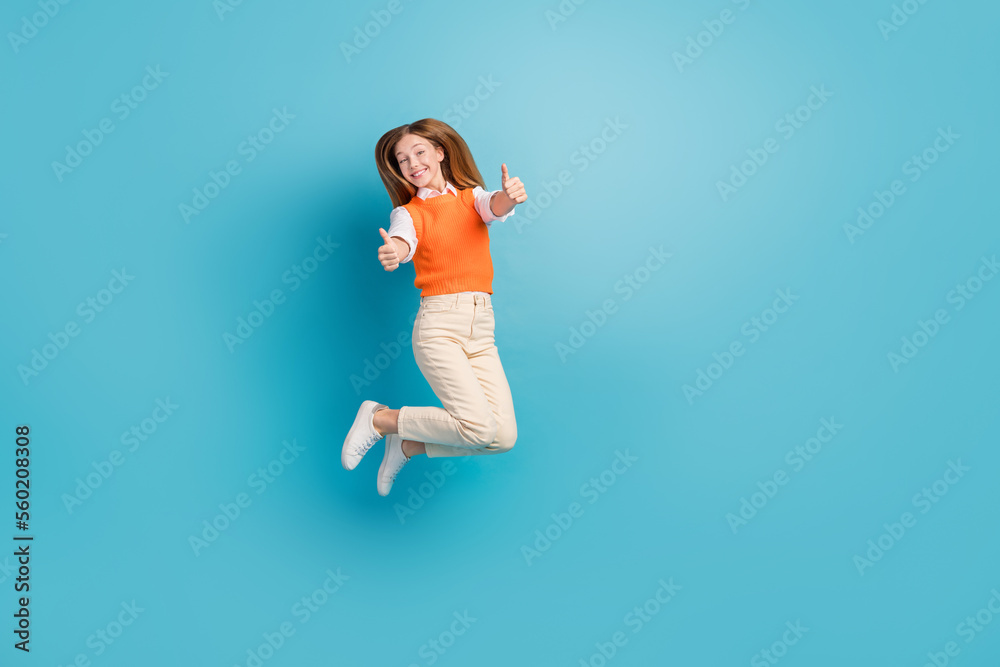 Full length photo of cheerful glad cute lady wear trendy clothes thumbs up nice choice empty space isolated on blue color background