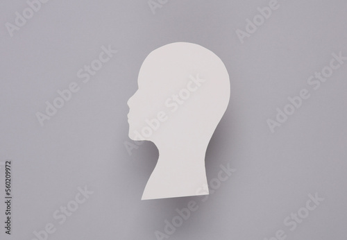 Paper cut white human head mockup on gray background photo