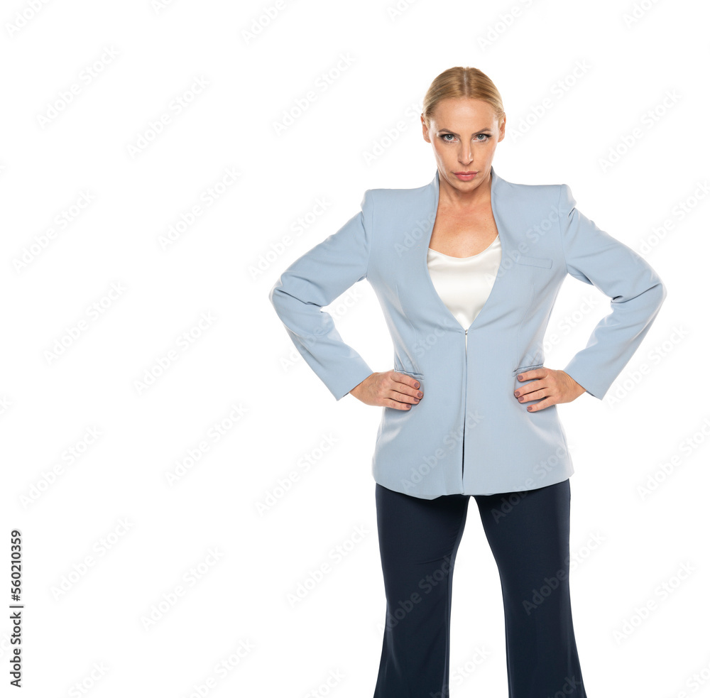 Angry middle aged senior woman wearing blue jacket and black trousers on a white studio background Angry middle aged senior woman wearing blue jacket and black trousers on a white studio background