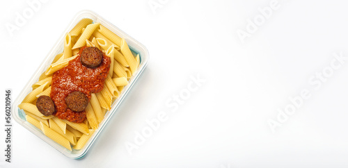 Macaroni with tomato sauce, chorizo and cheese in plastic container