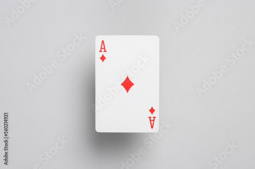 Ace of diamonds on a gray background. Playing card photo