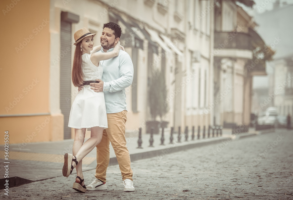 Romantic love concept. International couple. Man with woman hugs in city Romantic love concept. International couple. Man with woman hugs in city