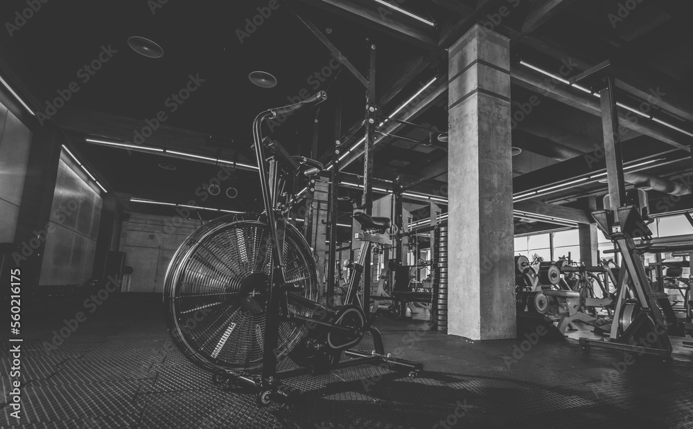 Air bike in the modern gym. Functional training. Gym interior Air bike in the modern gym. Functional training. Gym interior
