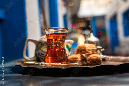 baklava with tea on a brown plate