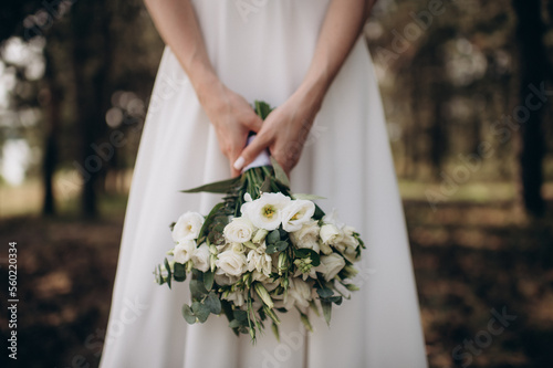 beautiful young bride with bouquet of flowers in brides hands